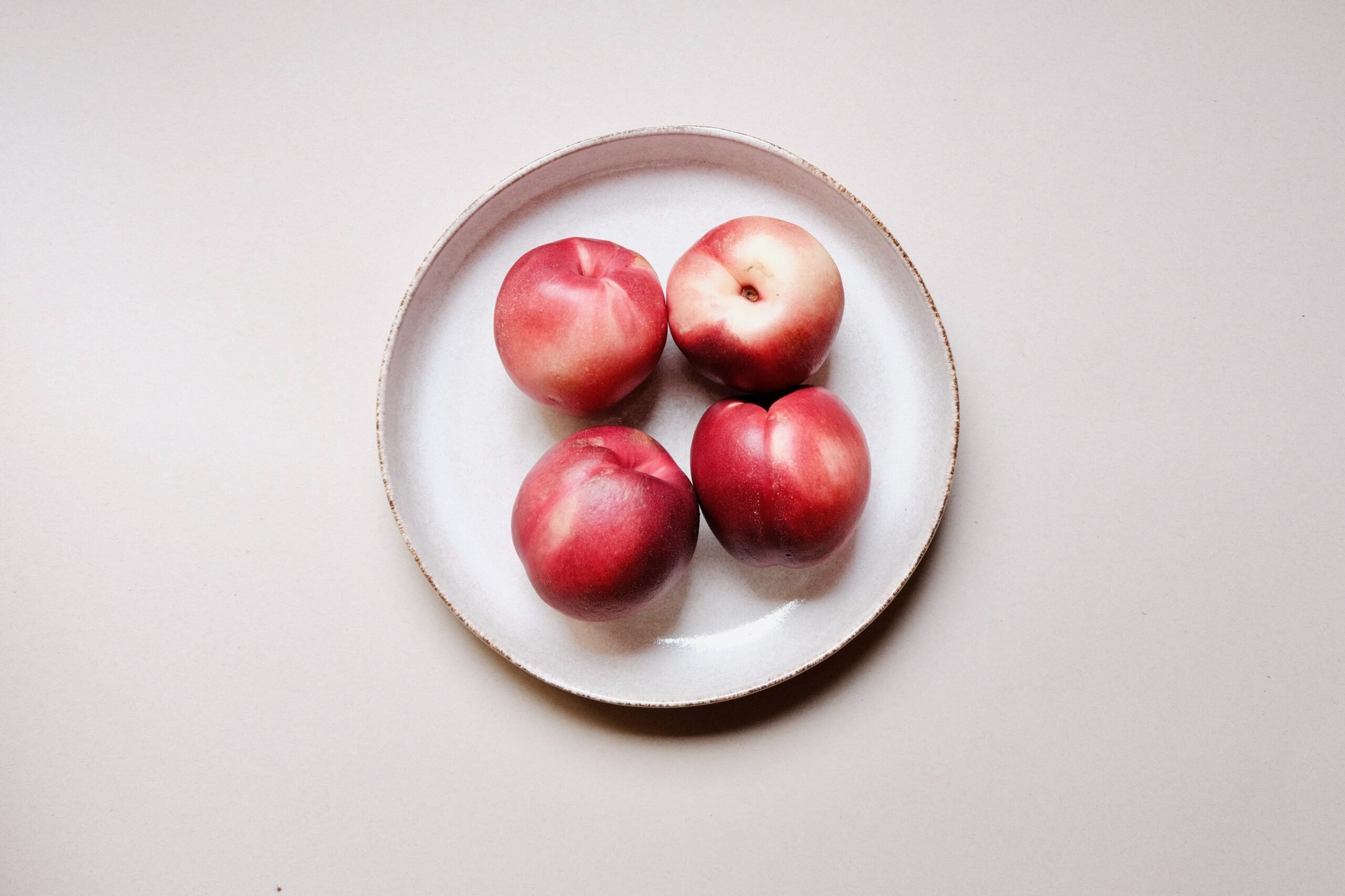 4 Nectarines on a plate